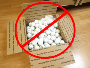 A box of golf balls with a red circle and line going through it. Implying not to give golf balls as a gift.