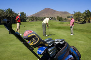 Foursome playing golf. 